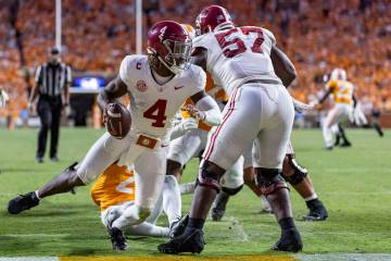 Alabama quarterback Jalen Milroe (4) avoids being tackled for a safety during the second half o ...