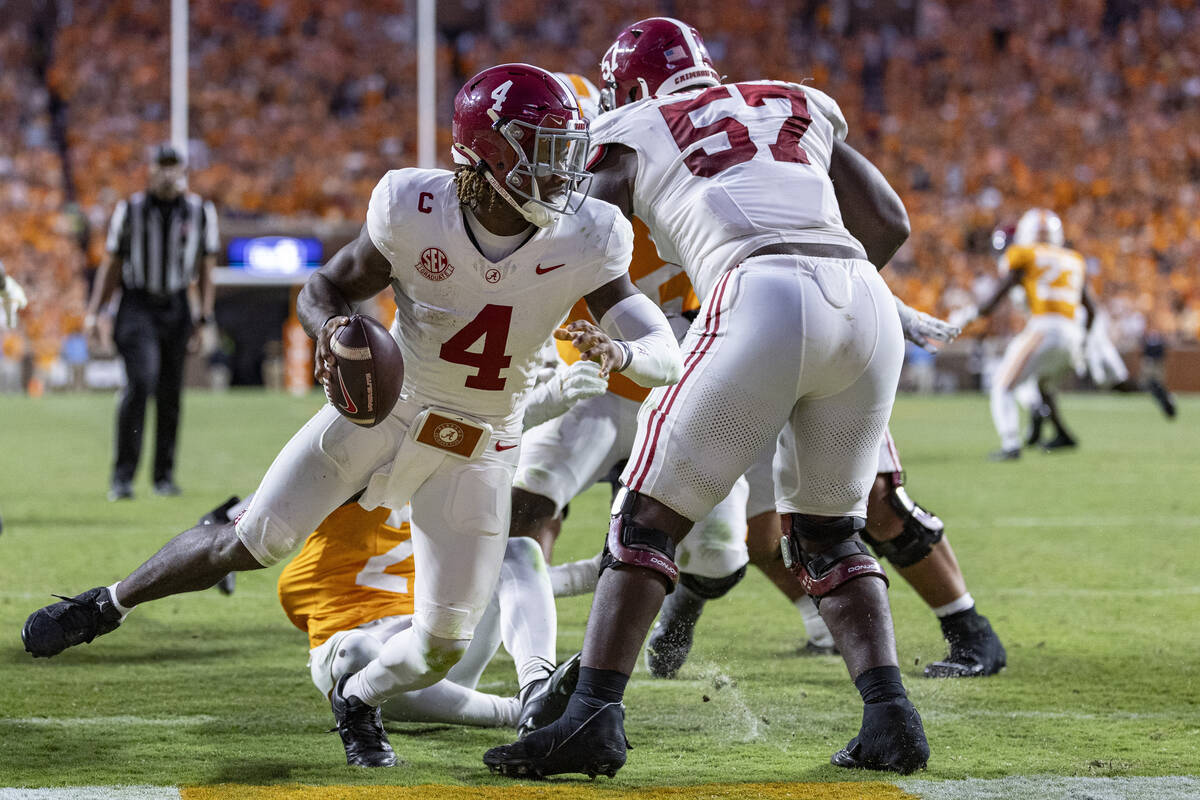 Alabama quarterback Jalen Milroe (4) avoids being tackled for a safety during the second half o ...