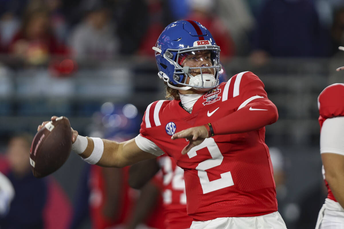 Mississippi quarterback Jaxson Dart (2) warms up before facing Duke in the Gator Bowl NCAA coll ...