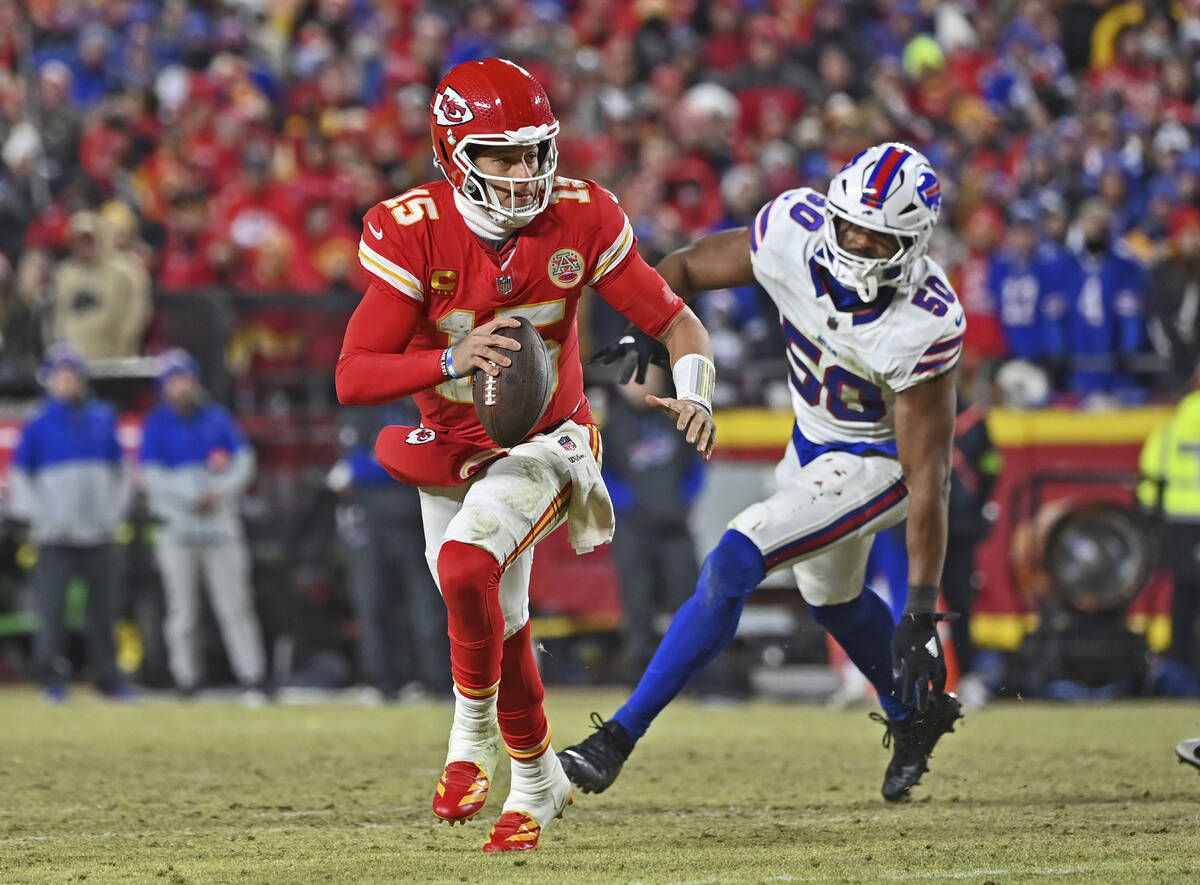 Kansas City Chiefs quarterback Patrick Mahomes (15) runs to the outside against pressure from B ...