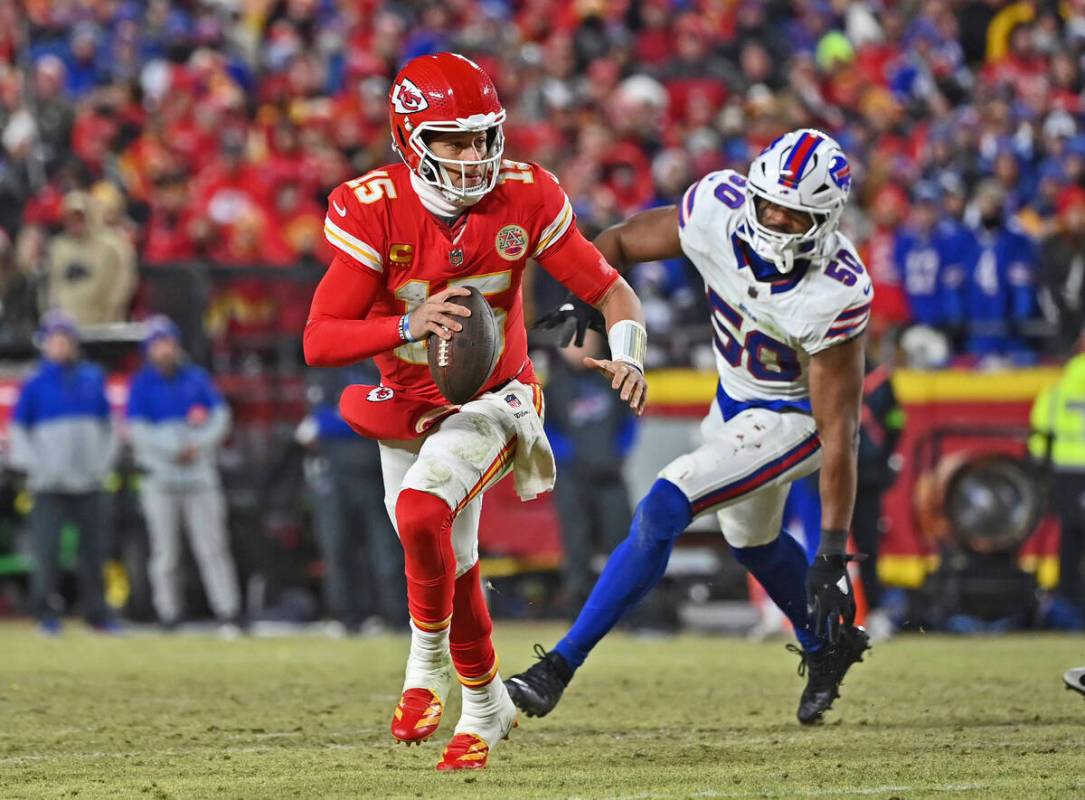 Kansas City Chiefs quarterback Patrick Mahomes (15) runs to the outside against pressure from B ...