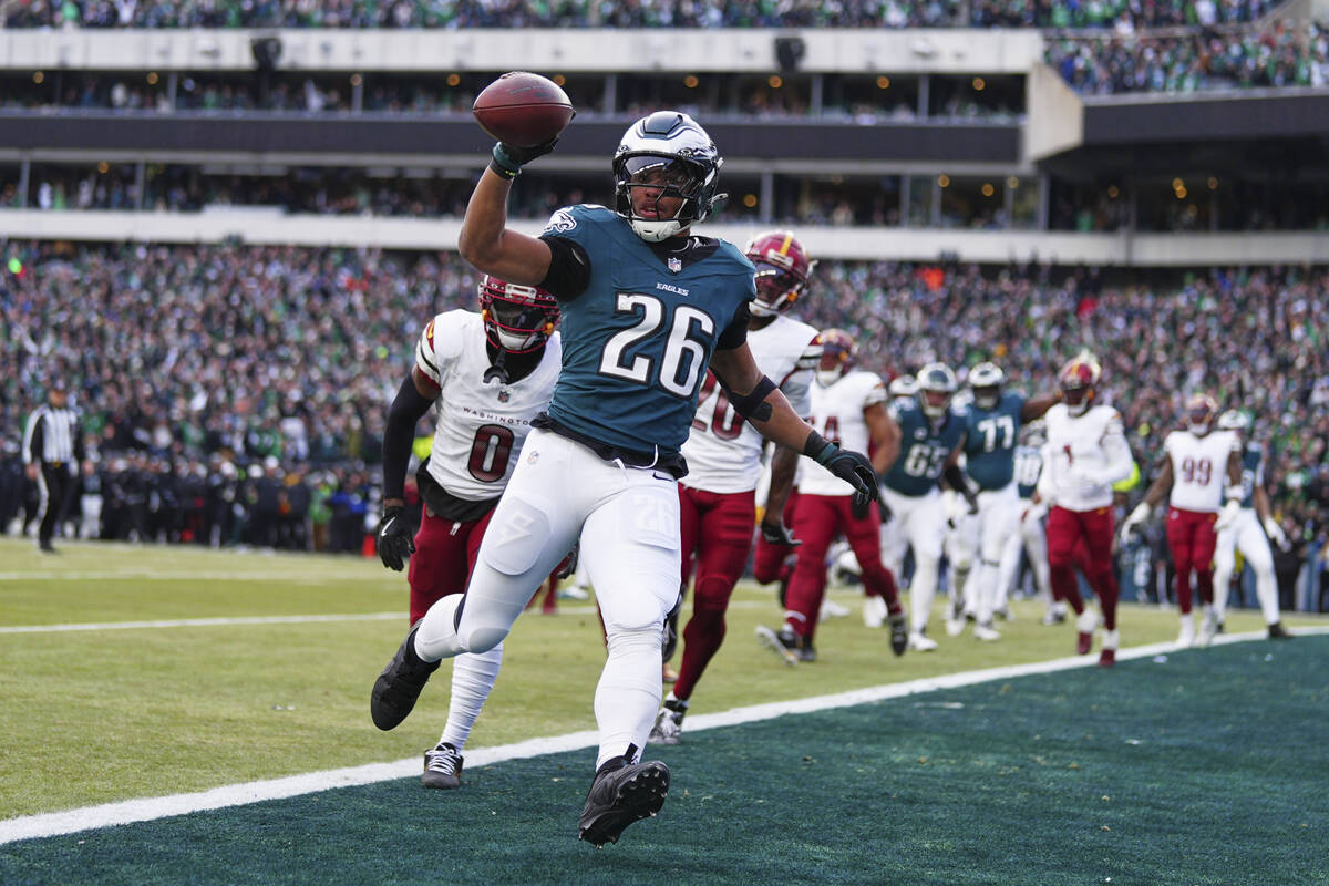 Philadelphia Eagles running back Saquon Barkley (26) scores a touchdown as Washington Commander ...