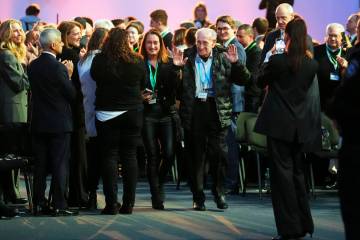 Holocaust survivor David Mandel is applauded has he arrives to attend the Commemoration Ceremon ...