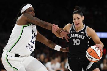 Minnesota Lynx forward Myisha Hines-Allen (22) fouls Las Vegas Aces guard Kelsey Plum (10) duri ...