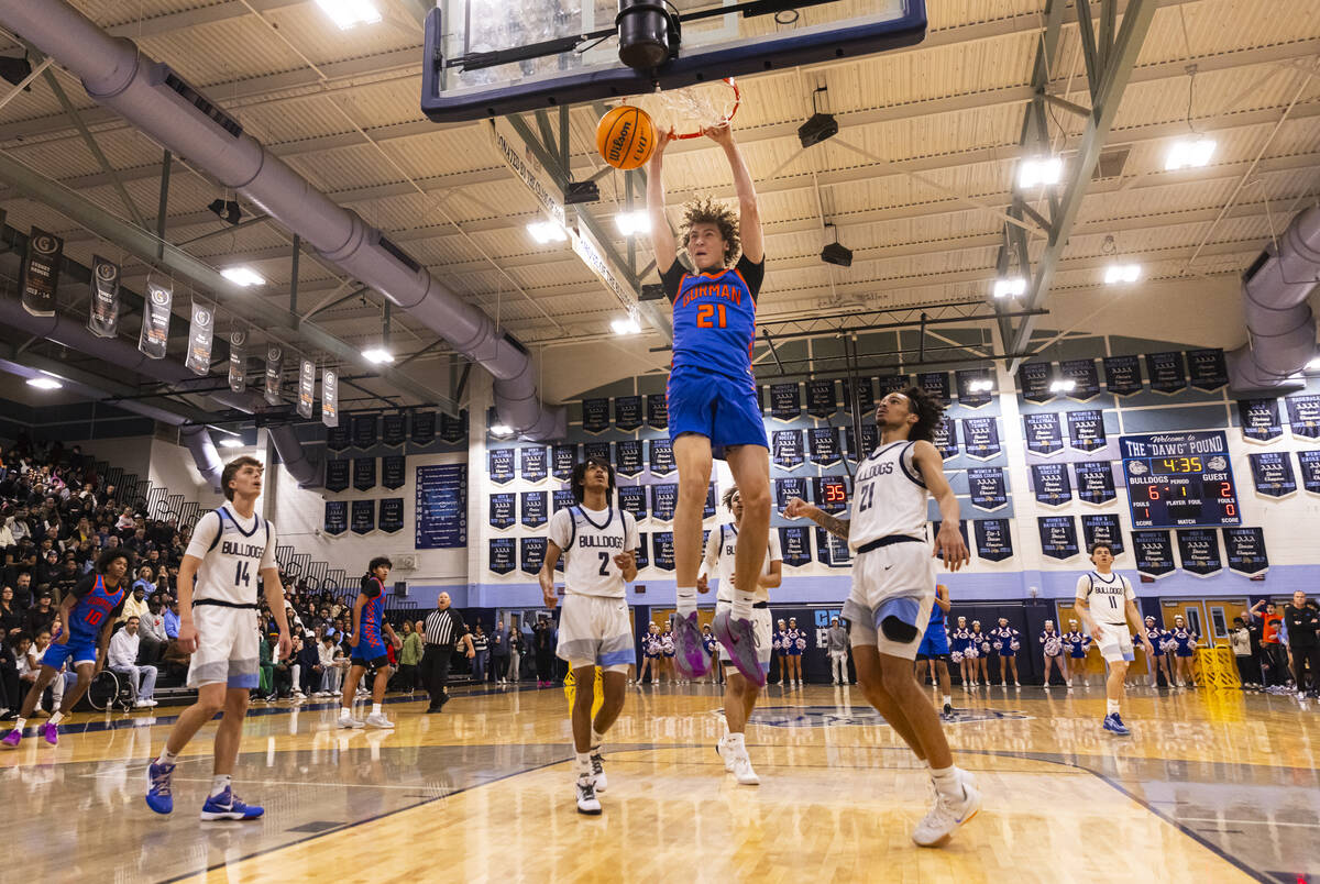 Bishop Gorman center Chris Baudreau (21) dunks the ball during a basketball game at Centennial ...