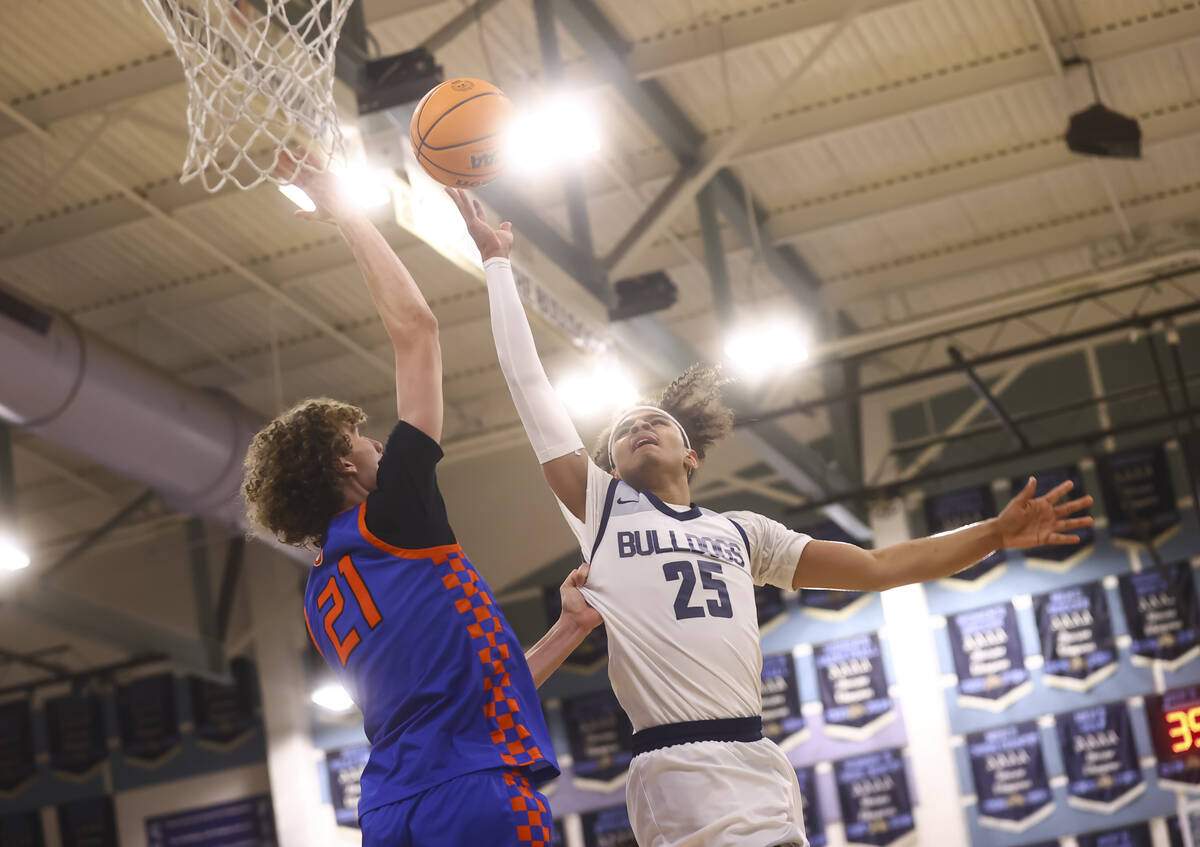 Centennial's Jayonni Durrough (25) lays up the ball against Bishop Gorman center Chris Baudreau ...