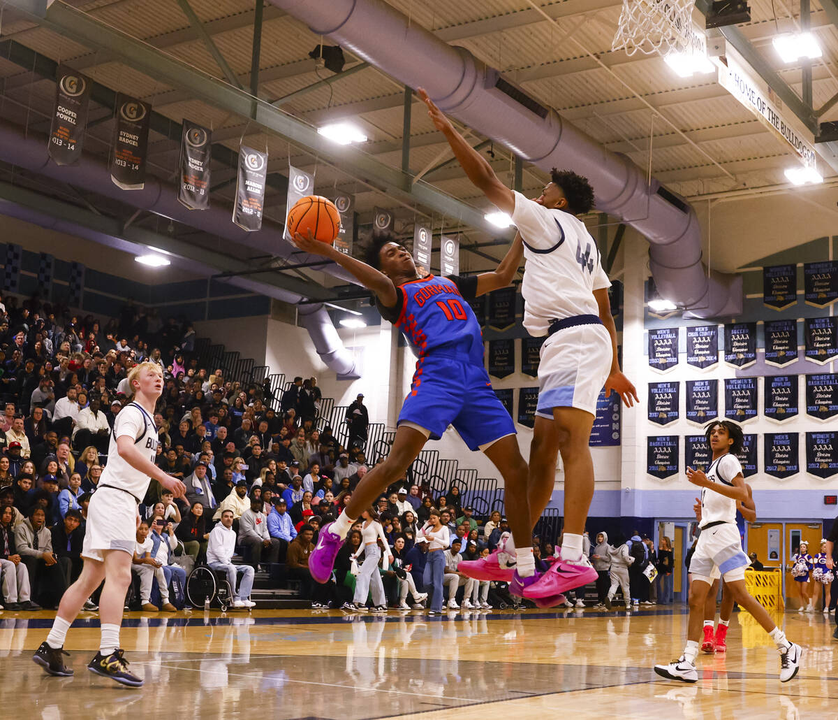 Bishop Gorman guard Nick Jefferson (10) tries to shoot around Centennial's Bryce Iwuoha (44) du ...