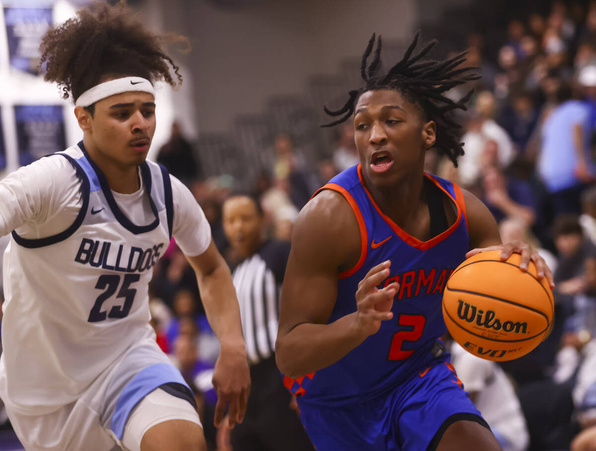 Bishop Gorman's Jett Washington (2) drives to the basket against Centennial's Jayonni Durrough ...