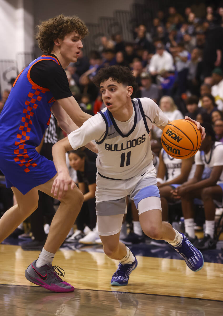 Centennial's Jaxon Price (11) drives to the basket against Bishop Gorman center Chris Baudreau ...