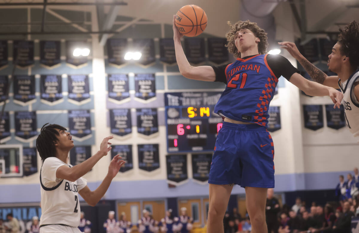 Bishop Gorman center Chris Baudreau (21) grabs a rebound during a basketball game at Centennial ...