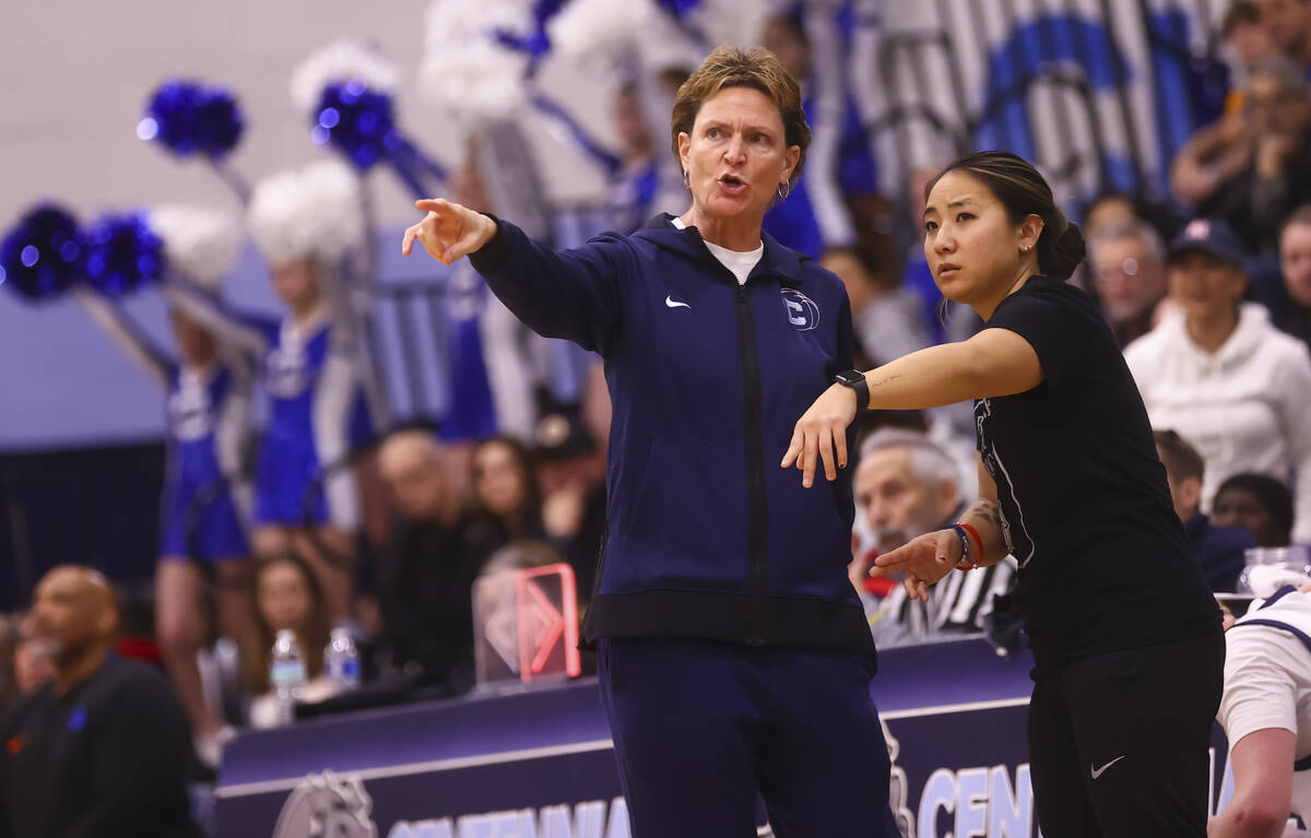 Centennial head coach Karen Weitz talks with assistant coach Riki Murakami as they take on Bish ...