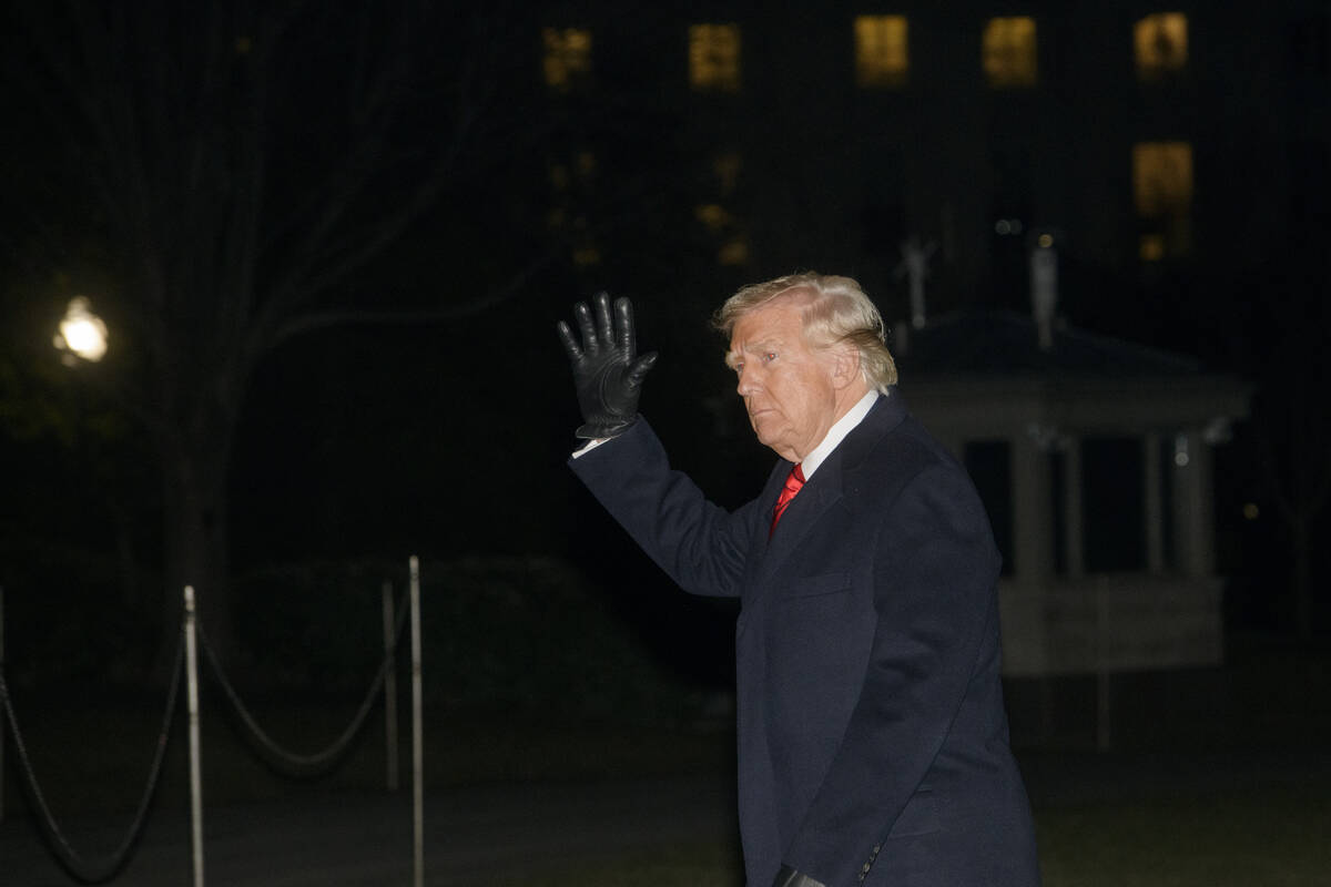 President Donald Trump waves as he walks from Marine One upon arrival on the South Lawn of the ...