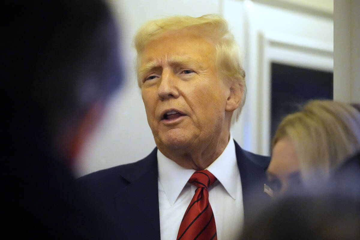 President Donald Trump speaks to reporters aboard Air Force One en route from Miami to Joint Ba ...