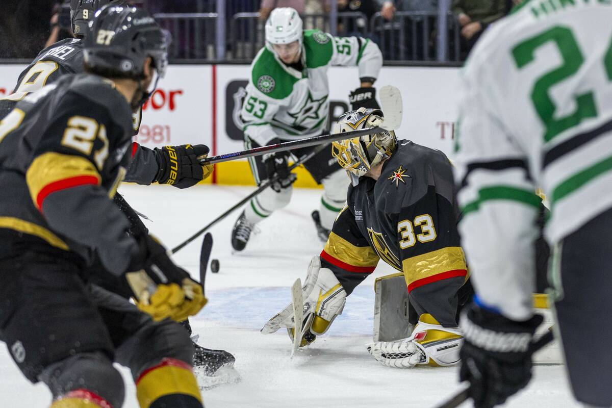 Golden Knights goaltender Adin Hill (33) looks on as Dallas Stars center Wyatt Johnston (53) ey ...