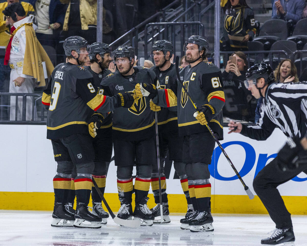 Golden Knights players celebrate an early score against then Dallas Stars during the first peri ...