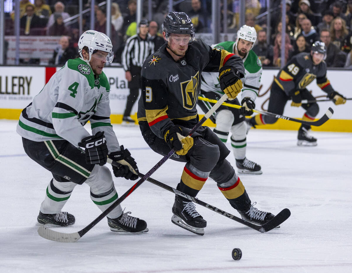 Golden Knights center Jack Eichel (9) looks to advance the puck against Dallas Stars defenseman ...