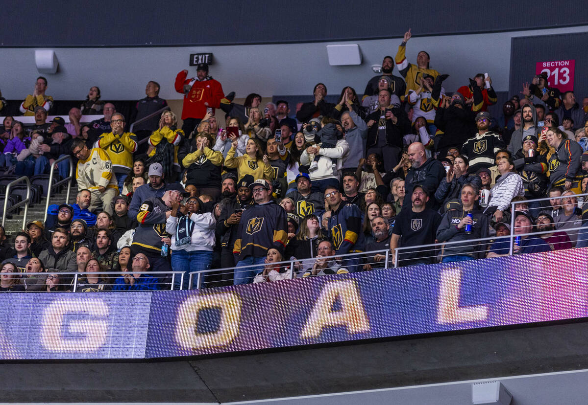 Golden Knights fans up top celebrate a goal over Dallas Stars goaltender Jake Oettinger (29) du ...