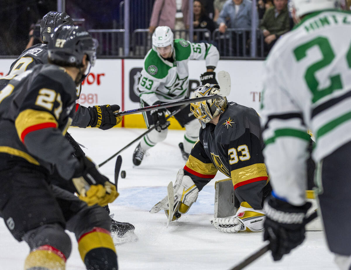 Golden Knights goaltender Adin Hill (33) looks on as Dallas Stars center Wyatt Johnston (53) ey ...