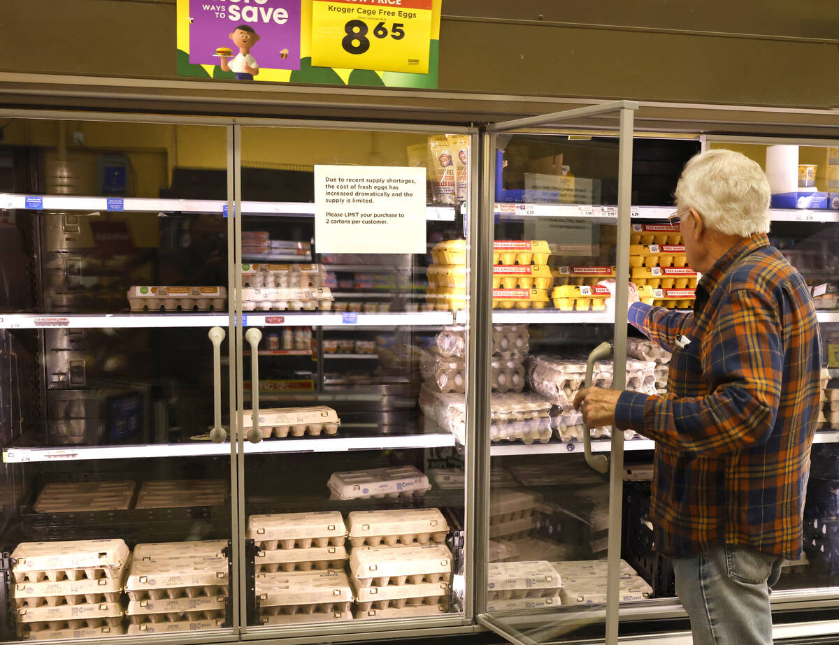 A customer picks a dozen eggs at a Las Vegas Smith’s, on Tuesday, Jan. 28, 2025, in Las ...