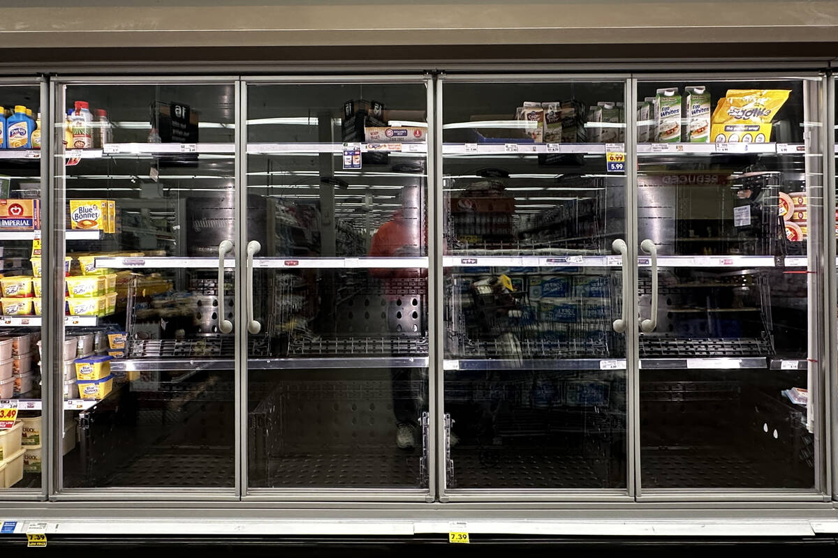 A refrigerated section that is normally stocked with eggs sits empty at a Las Vegas Smith’s J ...