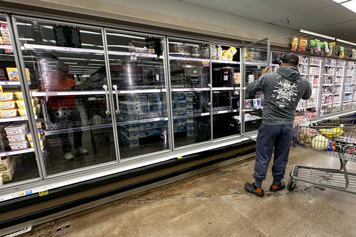 A refrigerated section that is normally stocked with eggs sits empty at a Las Vegas Smith’s J ...