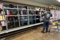 A refrigerated section that is normally stocked with eggs sits empty at a Las Vegas Smith&#x201 ...