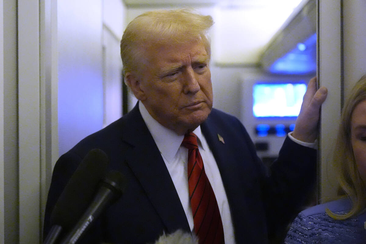 President Donald Trump speaks to reporters aboard Air Force One en route from Miami to Joint Ba ...