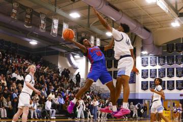 Bishop Gorman guard Nick Jefferson (10) tries to shoot around Centennial's Bryce Iwuoha (44) du ...