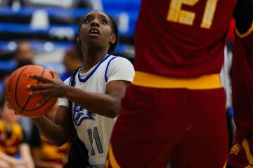 Basic point guard Kamilyah Williams eyes the basket during a girls basketball game between Basi ...