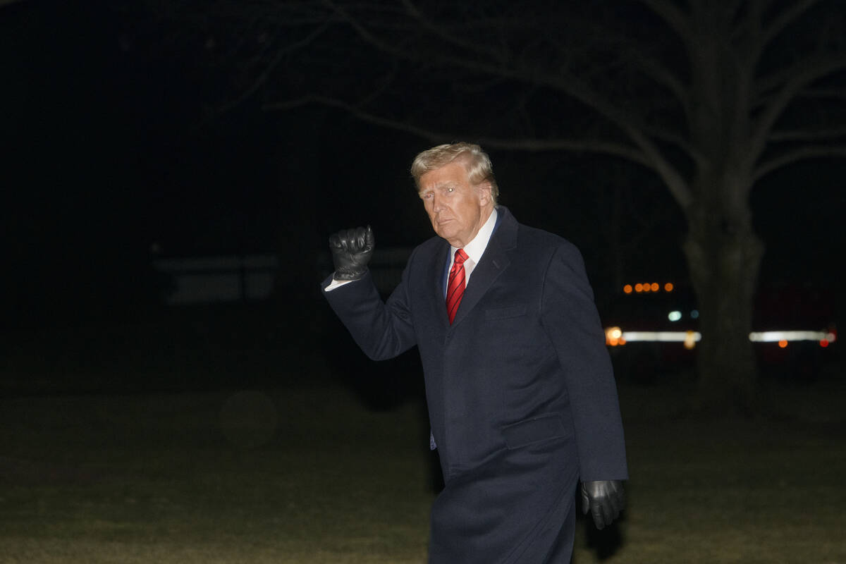 President Donald Trump waves as he walks from Marine One upon arrival on the South Lawn of the ...