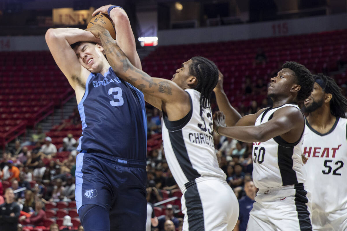 Miami Heat guard Josh Christopher (53) attempts to block Memphis Grizzlies forward Jake LaRavia ...