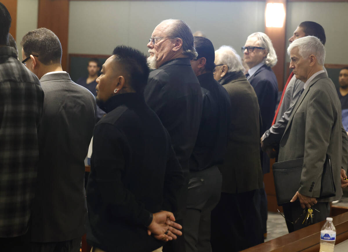 Defendants including Richard Devries, the president of the local Hells Angels chapter, center, ...