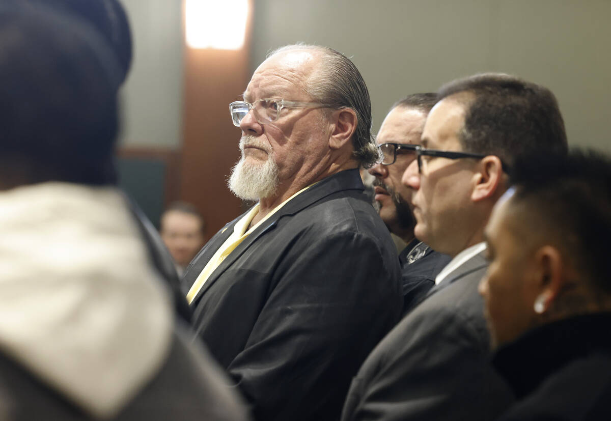 Richard Devries, the president of the local Hells Angels chapter, center, appears in court with ...