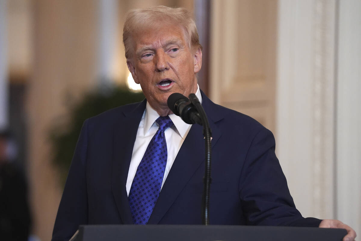 President Donald Trump speaks before signing the Laken Riley Act in the East Room of the White ...