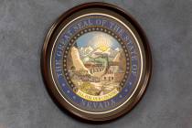 The Great Seal of the State of Nevada is hung on a wall in the Nevada Legislature building duri ...