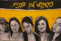 FILE - A mural of female Israeli soldiers who were abducted and brought to Gaza is displayed in ...