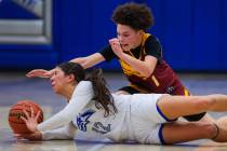 Basic shooting guard Mia Frias (12) struggles to keep hold of the ball as Del Sol guard Ricana ...