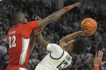 Utah State guard Deyton Albury (13) shoots the ball as UNLV forward Pape N'Diaye (22) defends i ...