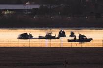 Search and rescue efforts are seen around a wreckage site in the Potomac River from Ronald Reag ...