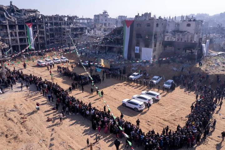 Red Cross vehicles, left, wait for the hand-over of Israeli soldier hostage Agam Berger at the ...