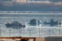 Emergency response units search the crash site of an American Airlines plane on the Potomac Riv ...