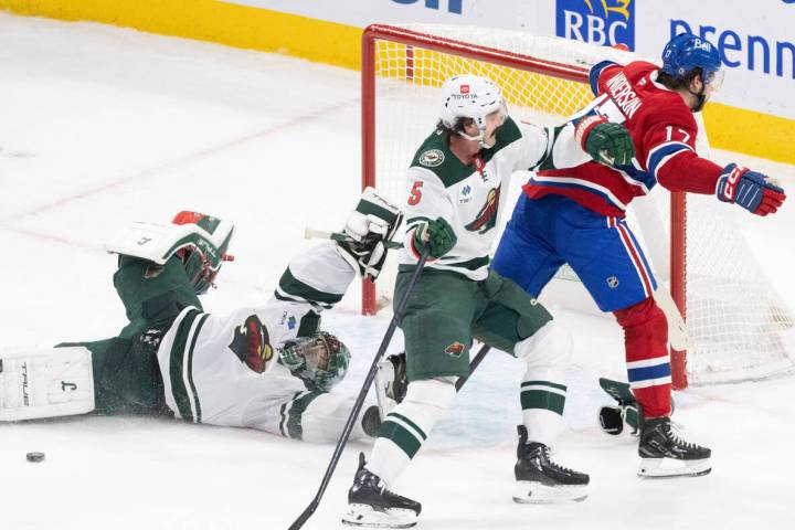 Minnesota Wild goaltender Marc-Andre Fleury, left, makes a save against Montreal Canadiens' Jos ...