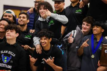 SLAM Academy wrestlers celebrate winning the Class 5A Southern Region NIAA wrestling meet at Sh ...