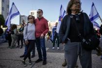 Israelis watch a broadcast of the release of Israelis Ofer Kalderon, 53, and Yarden Bibas, 34, ...