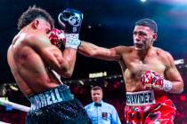 David Morrell Jr. takes a shot to the face from David Benavidez in round 4 of their WBC and WBA ...