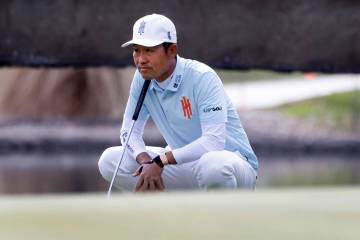 Kevin Na of team Iron Heads GC surveys the green on the 18th during the second round of LI ...