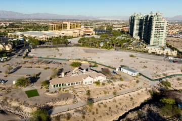 An aerial view of the shuttered Badlands Golf Course clubhouse, front, the Queensridge towers, ...