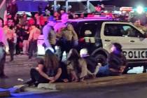 Protesters who were arrested sit on a median in Las Vegas on Monday, Feb. 3, 2025. (Martín Rod ...