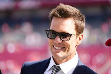 Former NFL quarterback Tom Brady makes an appearance on the field before an NFL football game b ...