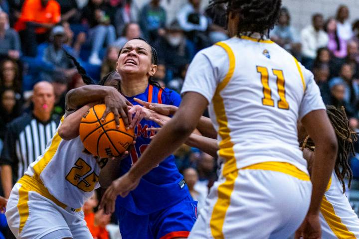 Bishop Gorman guard Aaliah Spaight (10) drives the lane as Democracy Prep forward ZhaNea Burrel ...